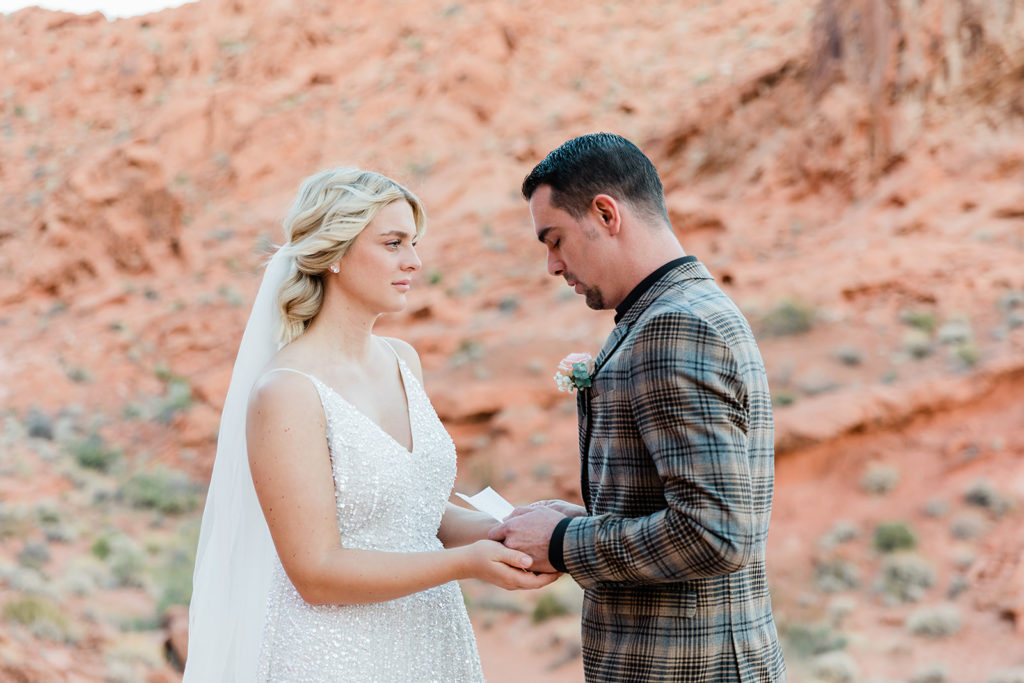 Groom saying his vows to his bride at Valley of Fire for their elopement in Las Vegas