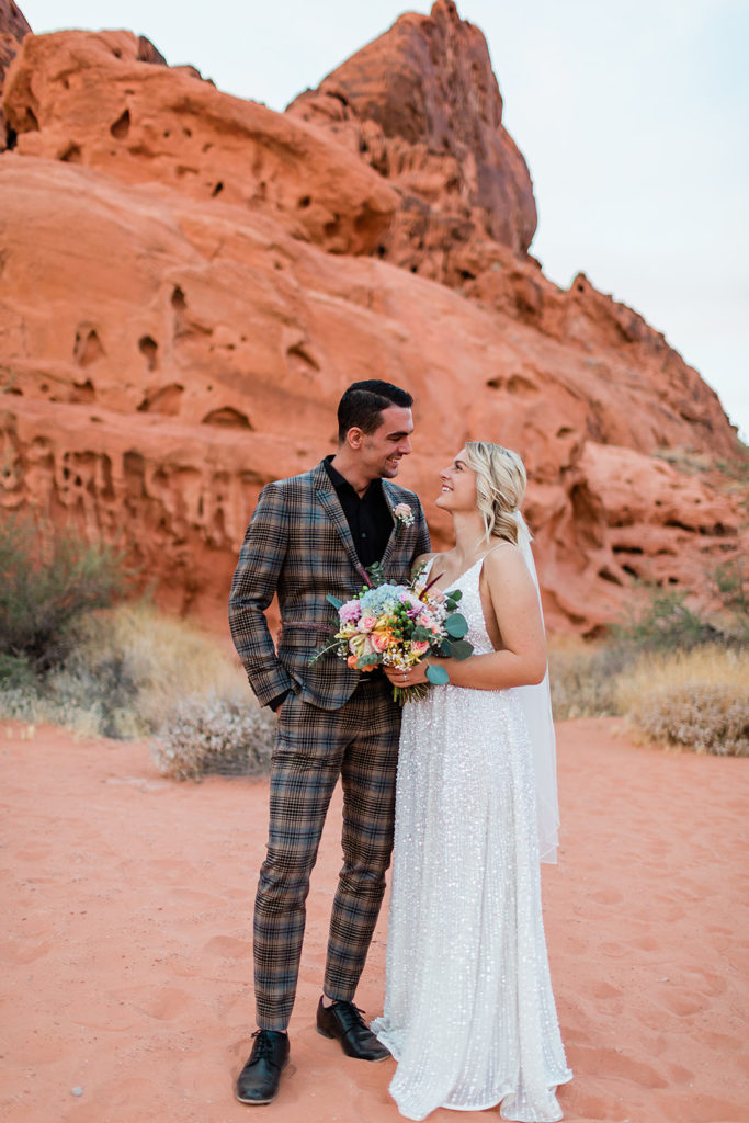 bride and groom smiling at each other celebrating their elopement at Valley of Fire on their wedding day