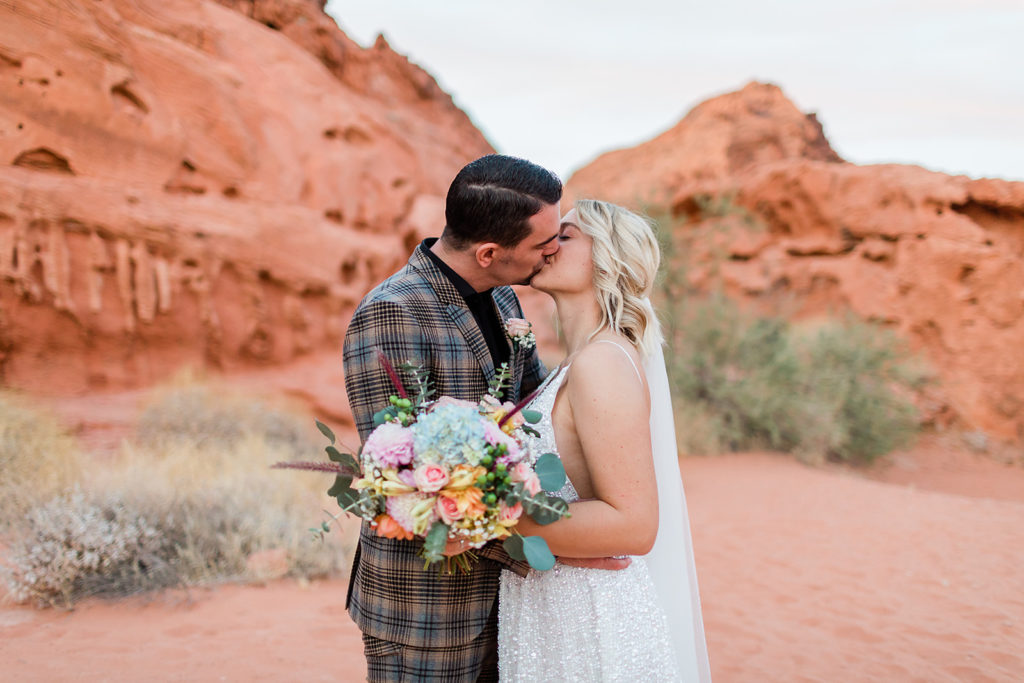 bride and groom kissing on their wedding day and having their elopement at Valley of Fire